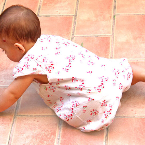 A cute baby girl crawling on the floor