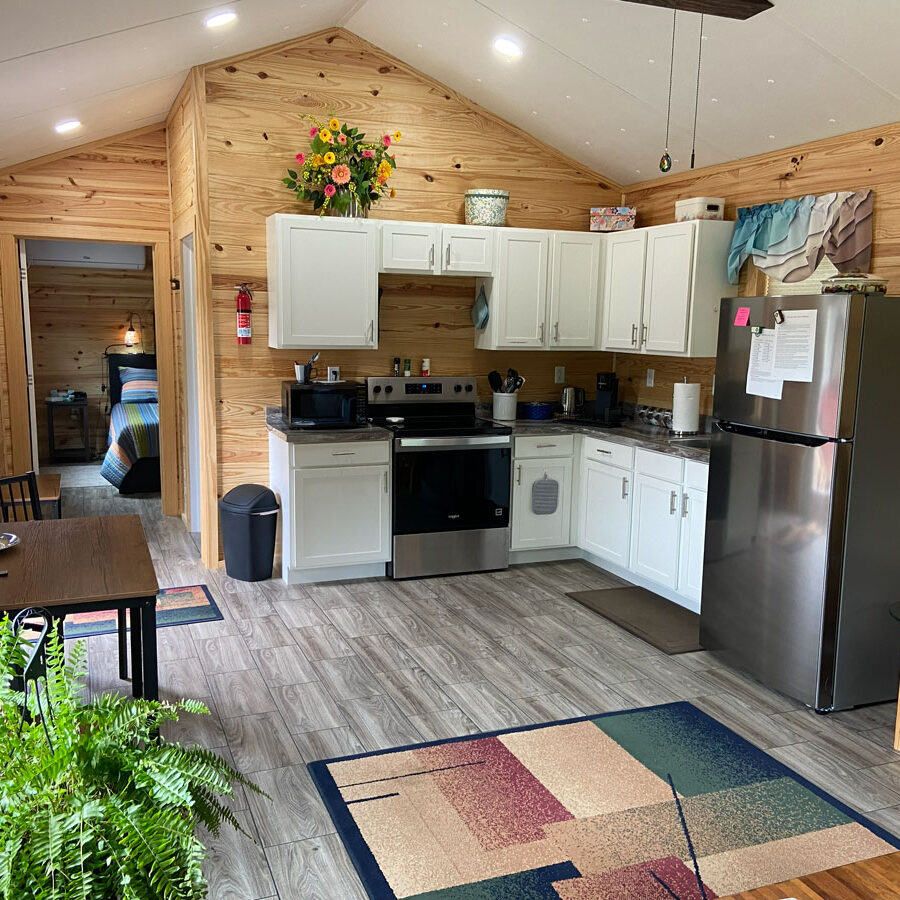 Inside of Small House. Showing kitchen, and a bit of the bedroom.