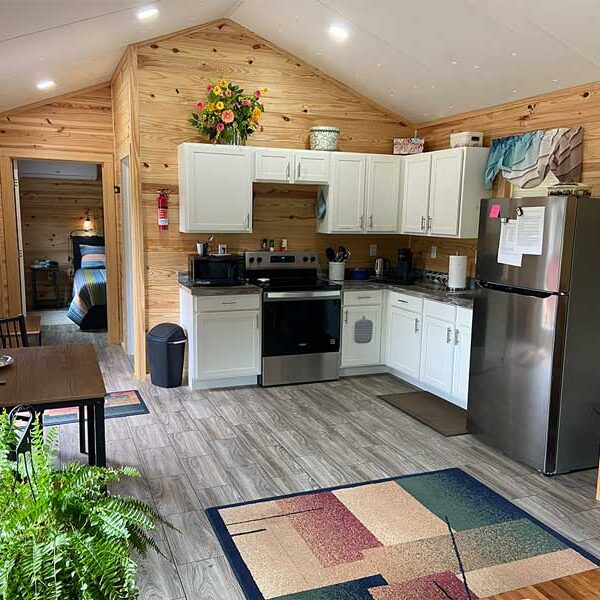 Inside of Small House. Showing kitchen, and a bit of the bedroom.