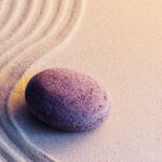 Purple Rock On Sand purple rock on a wavy zen sand background
